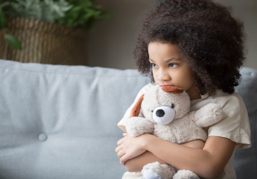 stressed girl holding a bear